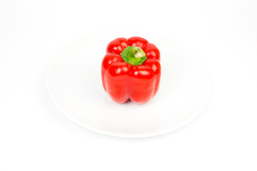 Paprika red on white plate on white backdrop