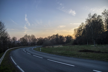 asphalt road to sunset