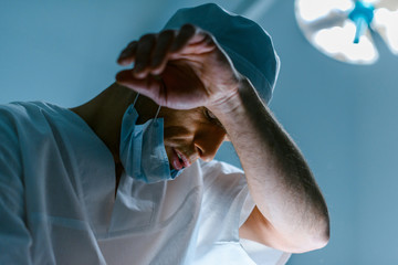 bottom view of tired doctor in operating room
