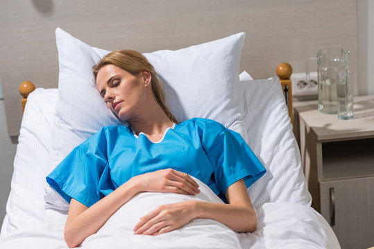 sick woman sleeping on hospital bed