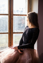 Fototapeta premium Beautiful woman in dream dress at window
