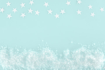 christmas background with decorative snow and stars, isolated on light blue