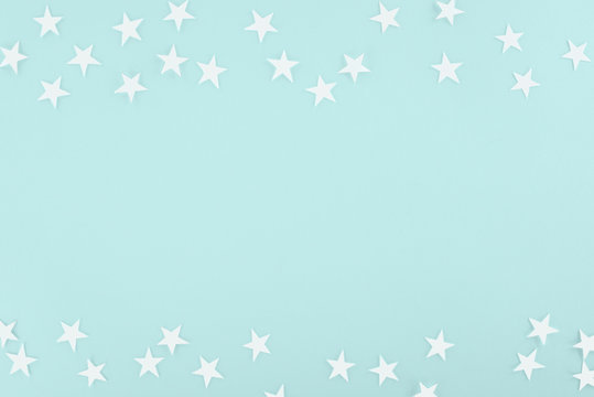 background with white paper stars, isolated on light blue