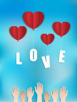 Love and Valentine’s day theme background. Hands to catching red balloons in heart shape are floating with love wording. Paper art style.