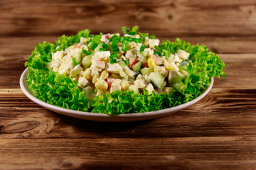 Salad with crab sticks, sweet corn, cucumber, eggs, rice and mayonnaise