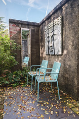 Characteristic patio with an opportunity to sit and a buddha sculpture on the wall