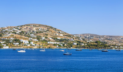 Greece. Cyclades. Paros island. Picturesque white houses near Parikia town. Yachts in the sea