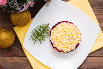 Traditional Russian salad -  in a plate. Christmas decoration. Top view