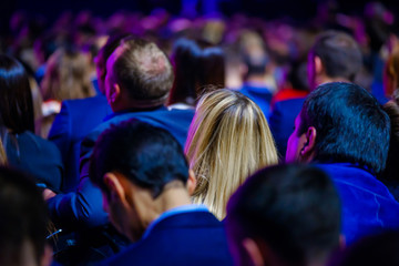 People attend business conference in the congress hall