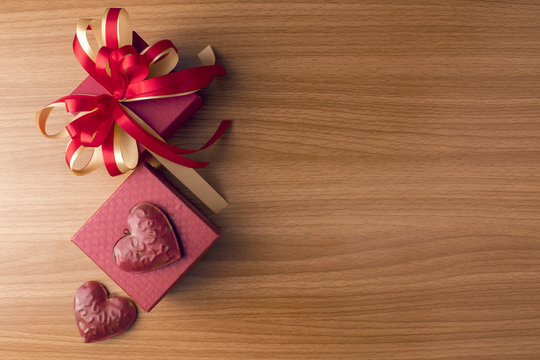 red gift box with heart love on wood ground in valentine concept