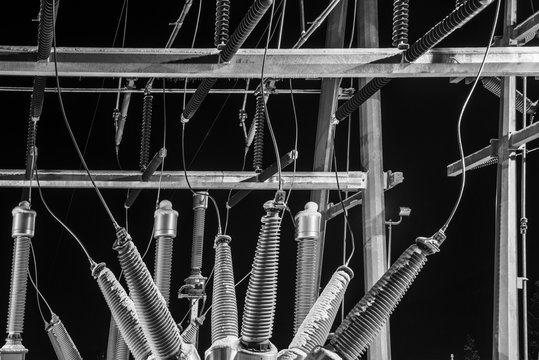 Low angle view of insulators against clear sky at night
