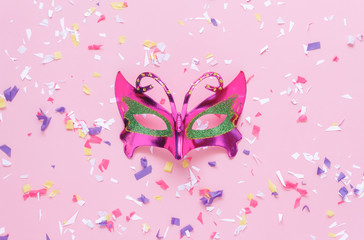 Obraz na płótnie Canvas Table top view aerial image of beautiful silver carnival mask background.Accessory object on modern rustic pink wallpaper at home office desk studio.free space for creative design text and font.