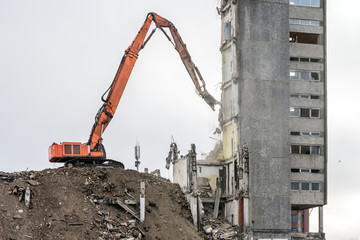 Building demolition with hydraulic excavator