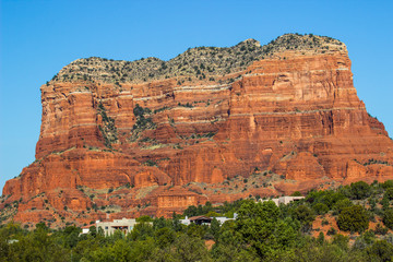 Red Rock Mountain With Layers Overlooking Houses In Arizona Desert