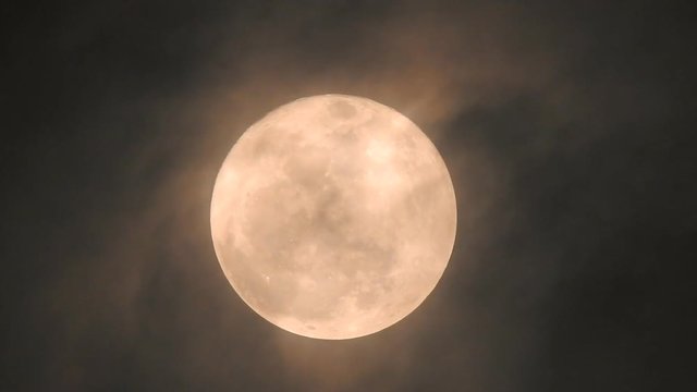 The yellow full moon and cloud video on black background for your night and dark design concept. High Quality of full moon photo.