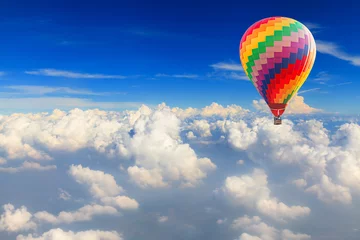 Tuinposter Hot air balloon over the white cloud on blue sky © Naypong Studio