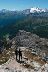 Fototapeta na wymiar Young Couple Admire Italian Dolomites Alps Scenery