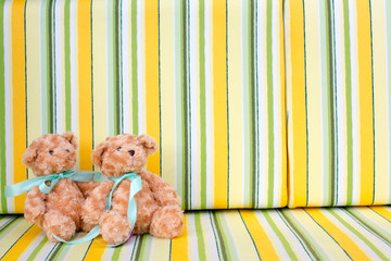Teddy bears sitting on colourful background