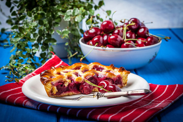 Homemade cherry pie on blue table.