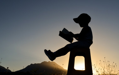 cute little boy reading story book