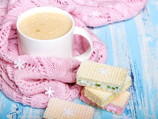 Tasty Christmas coffee or cocoa and sweet cookies on blue wooden background and pink tablecloth. Copy space
