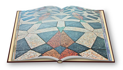 Opened photo book with the detail of the colored stone paving of the "Amagertorv square", along the Stroget road, made of triangular and polygonal granite stones (Europe - Denmark - Copenhagen)