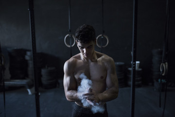 Man ready for training on ring with magnesium on hands
