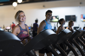 Fototapeta na wymiar Group of people training running treadmill in gym