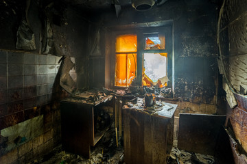 Burnt apartment house interior. Burned furniture and charred walls in black soot