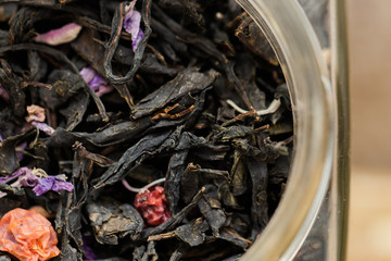 Dried black tea leaves in jar close up