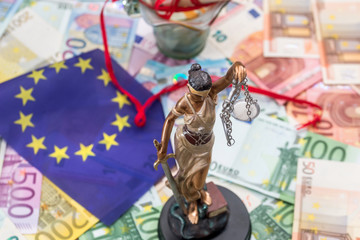 Themis with euro banknotes and flag of europe