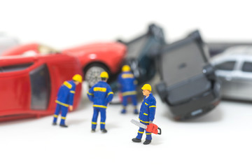 Fototapeta premium miniature rescue team are removing car crash from the road isolated on white background