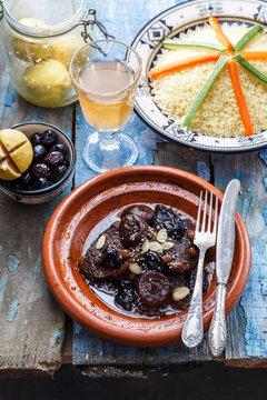 Traditional moroccan dishes: beef tajine, couscous, olives and salted lemons. Rustic style