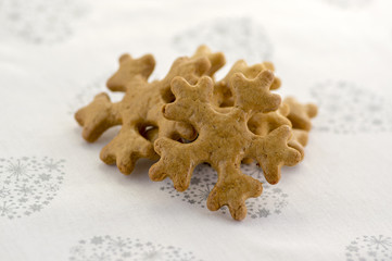 Traditional tasty Czech gingerbreads, Christmas snowflakes on white tablecloth with hearts and stars