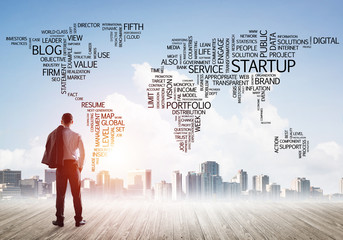 Motivation and inspiration concept with modern cityscape and businessman observing it