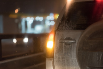 cars at night in a traffic jam in winter frost