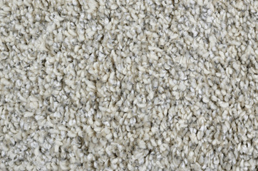 Close-up of grey woolen shaggy carpet surface