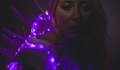 technology, blonde girl with white helmet of the future surrounded by purple leds lights