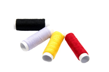 Colorful spools of thread isolated on white background