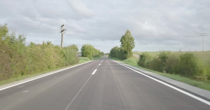 Backplate aerial flight along country road