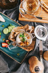 a beautiful layout of food for breakfast: a jar with pate and mushrooms and a cup of tea
