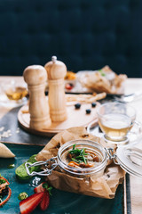 a beautiful layout of food for breakfast: a jar with pate and mushrooms and a cup of tea