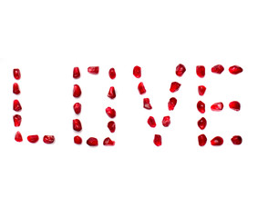 Inscription love of pomegranate grains on white white background.Concept love, valentine's day.Font