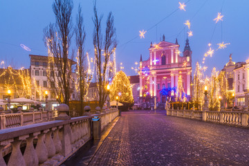 Presern square, Triple bridge and Franciscan Church of the Annunciation decorared by Christmas lights in Ljubljana, Slovenia