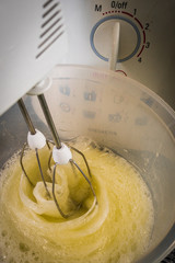 A kitchen mixer beating egg whites for cake, batter or dough used during baking and cooking. - 186578199
