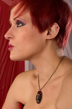 Pretty Pale Model with Red Hair in Cardboard Corset in Experimental Trash Bag Cardboard Set with Bone Twin Pendant. Jewelry by WeeGonza Bazaar. Model: Amanda