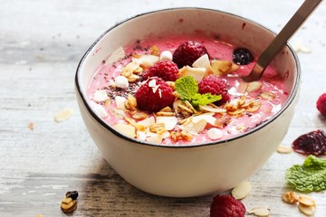 Raspberry Smoothie Bowl / Healthy breakfast concept, selective focus