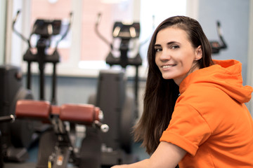 Fototapeta na wymiar Young woman in a gym smiling after workout