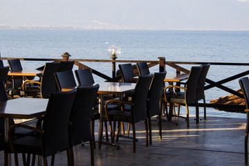 Tables in a cafe on the beach. Selective focus.