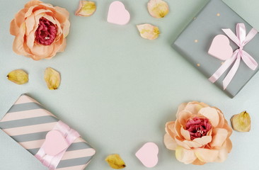 Valentine's day concept background. Pink hearts, flowers, gifts on pale grey background. Flat lay. Top view. Copy space